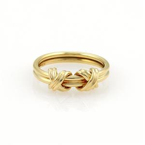 Tiffany & Co. 18k Yellow Gold Double X Crossover Band Ring Size 4.5: This is an authentic ring from Tiffany & Co. in the X Crossover collection, it is crafted from 18k yellow gold in a fine polished finish. The ring is in the style of a thick double wire band with two