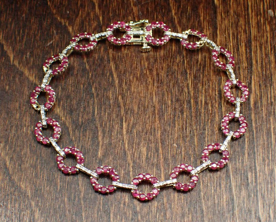 RUBY, DIAMOND AND FOURTEEN KARAT GOLD BRACELET: RUBY, DIAMOND AND FOURTEEN KARAT GOLD BRACELET. The 7-1/4" yellow and white gold bracelet set with 120 round-cut rubies together weighing approximately 3.60 cts; and 60 round-cut diamonds together wei