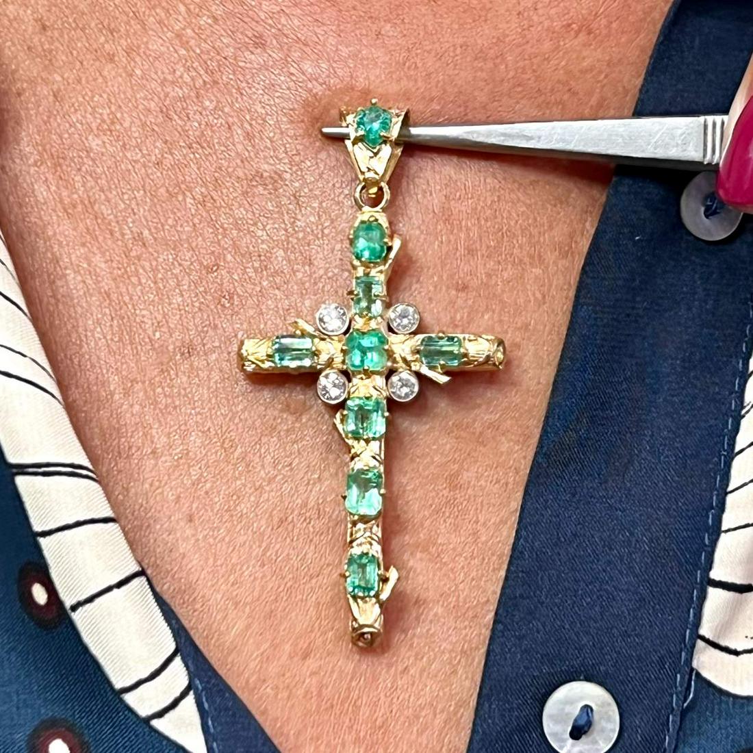 18K Yellow Gold Colombian Emerald & Diamond Cross: 18K Yellow Gold Colombian Emerald & Diamond CrossWeighing 8.9 gramsSet with 9 Colombian Emeralds weighing app. 4.00 Ct.Along with 4 Diamonds weighing app. 0.60 Ct.F-H Color, VS1-SI1 Clarity2.75 inches