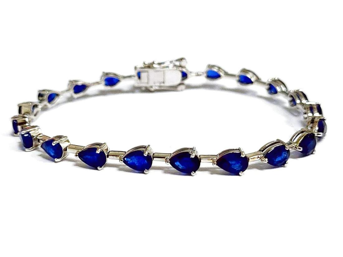 11.7Ct Pear shaped Blue Sapphire Link Tennis Bracelet 14K Gold: LOVELY ,14K Gold weight : 7.42 Gr.Color : White and Yellow GoldStone weight : 11.70Ct Tw.Stone type : Pear shaped Blue SapphireSize : 7"