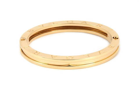 Bvlgari B Zero-1 Engraved 18k Yellow Gold Bangle Bracelet 6.5: This authentic yellow gold mid size bracelet is from Bulgari, it is well crafted from 18k yellow gold with a polished finish. The flat surface on both sides are stamped BVLGARI twice. It comes from th