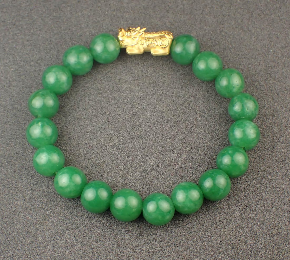 JADE AND TWENTY-TWO KARAT GOLD FENG SHUI BRACELET (1 of 4)