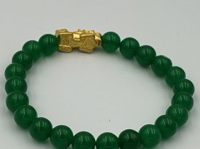 MAGNIFICENT LARGE JADE AND 22K GOLD BRACELET