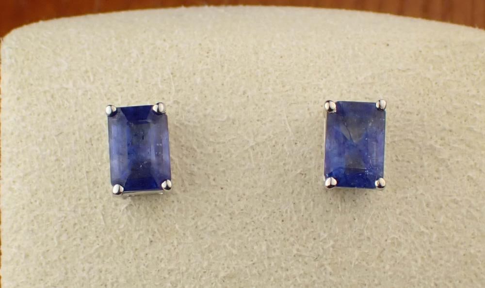 SAPPHIRE AND GOLD EAR STUDS: SAPPHIRE AND FOURTEEN KARAT GOLD EAR STUDS, each white gold ear stud set with an emerald-cut blue sapphire. Total combined weight for both sapphires: 1.96 cttw. The gold post on each ear stud is stamp