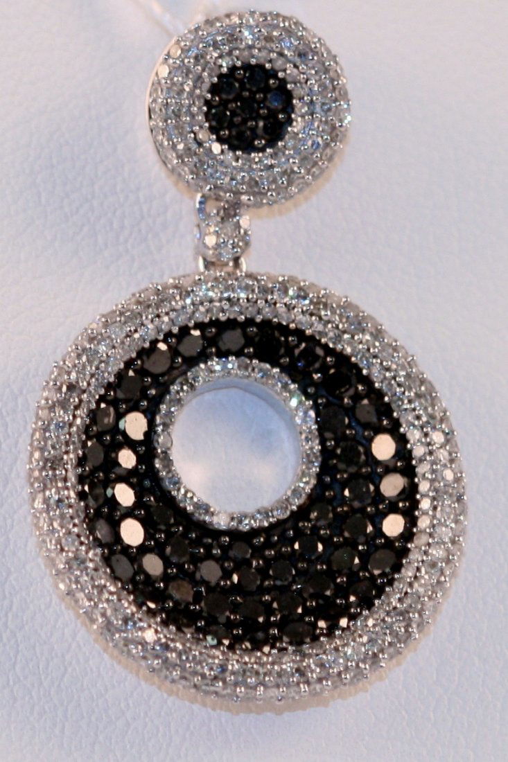 Designer 14k White gold pendant with white and black di: One designer 14k white gold pendant weighting 5.8 grams of 14k white gold. This pendant has a total diamonds weight of 2.00cts , made up of full cut round brilliant white and black diamonds.