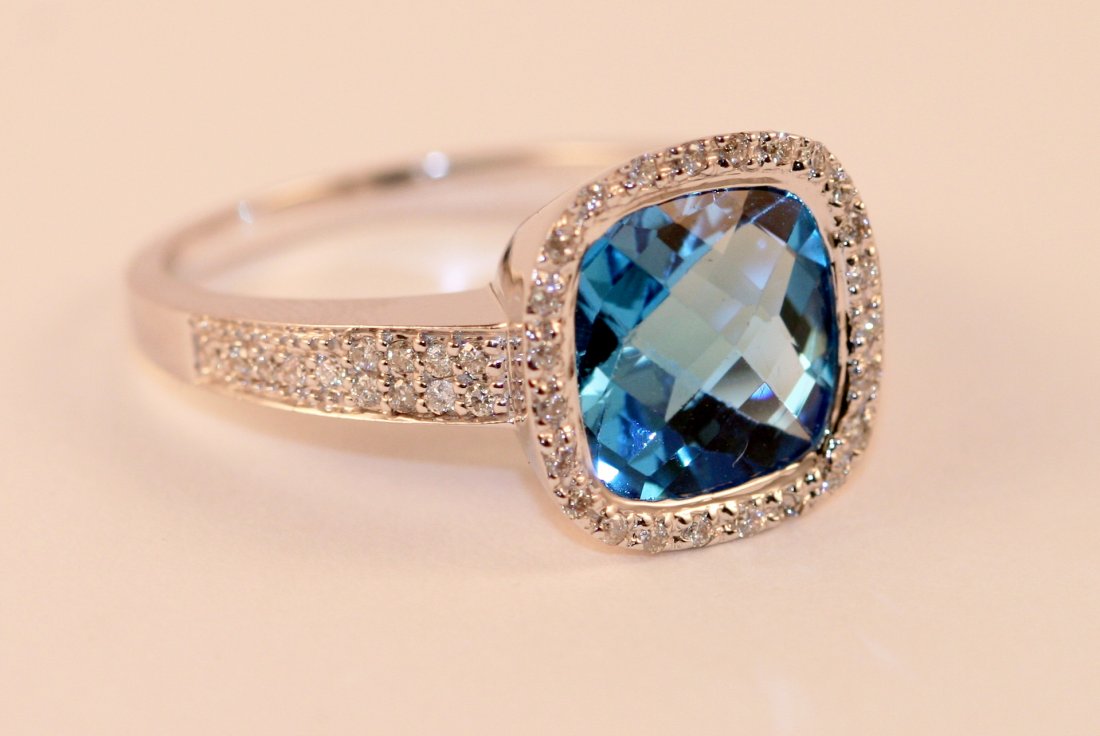 14k White Gold Diamond and Blue Topaz Ring.: One 14k white gold diamond and blue topaz ring weighting 5.2 grams of 14k gold. This ring has a total diamond weight of .23carats , all of which are full cut round brilliant stones. The blue topaz wei