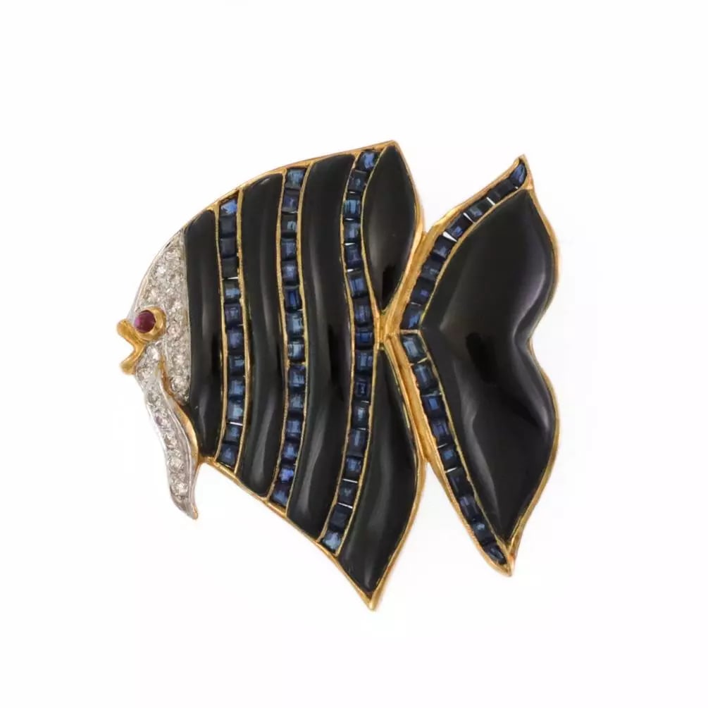 Diamond Gemstone Onyx Brooch 18k Gold Fish Design: This Diamond Gemstone Onyx Brooch in 18k Gold Fish Design is a stunning piece of vintage and antique jewelry for women. The channel-set multi-tone gold base metal holds square-shaped blue stones, and