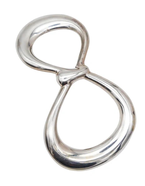 TIFFANY & CO 1975 Elsa Peretti Abstract Buckle-Pendant In.925 Sterling Silver: Pendant-buckle designed by Elsa Peretti (1940-2021) for Tiffany & Co.This is a gorgeous sculptural pendant-buckle created by the iconic Elsa Peretti for Tiffany & Co., back in the 1975. This