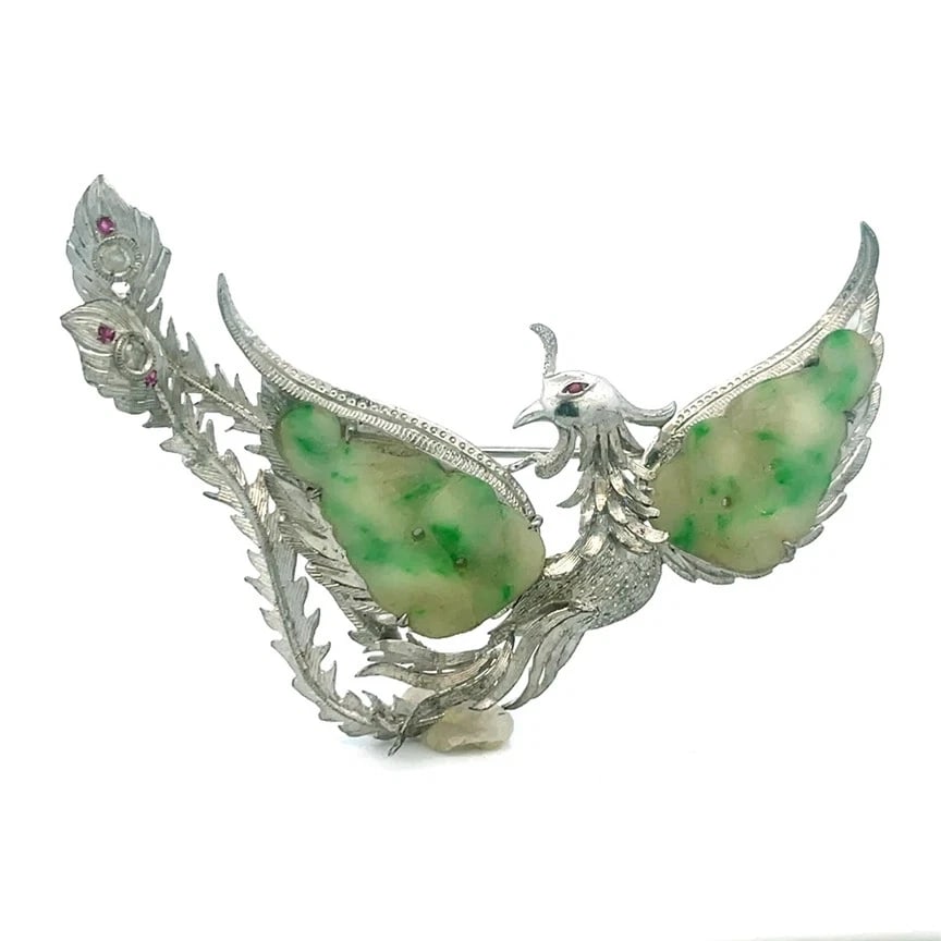 Jade Sterling Silver Phoenix Brooch Vintage Detail Bird Design Gemstones: This beautiful jade sterling silver brooch is a vintage piece of jewelry featuring a mythical Phoenix bird design with intricate details and a wide wingspan. The brooch has natural green jade stones s
