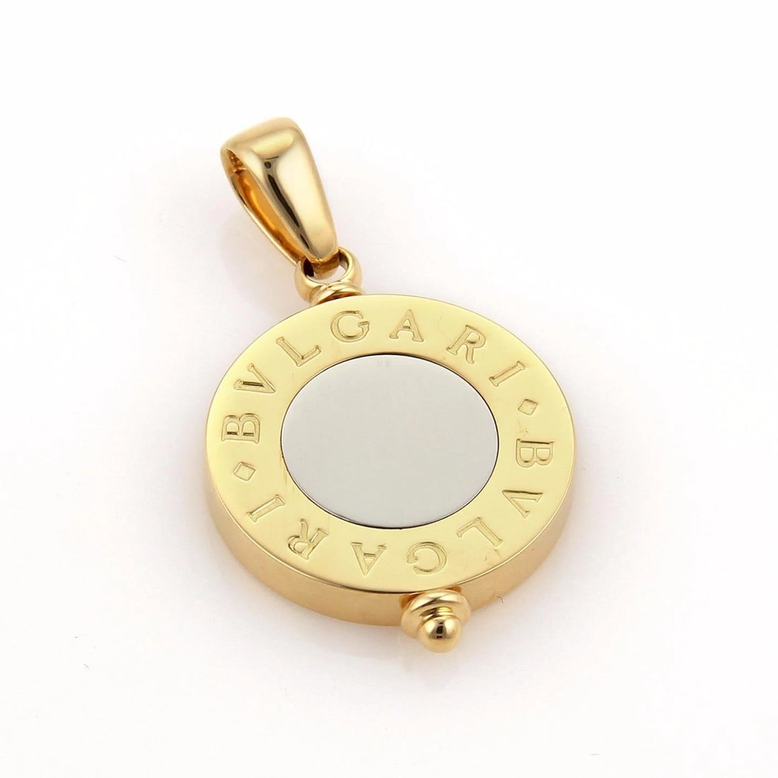 Bvlgari Bvlgari Gold Pendant 18k Yellow & Steel Signature Circle Disc: The Bulgari gold and steel pendant is a luxurious jewelry piece featuring a round disc with engraved BVLGARI BVLGARI in 18k yellow gold and a steel disc set in the center of the gold bezel. This