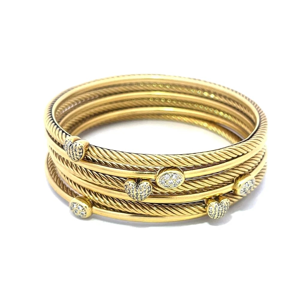 David Yurman Set of 6 Gold Bangles Diamond 18k Yellow 3mm Cable Style: These beautiful bangles are by David Yurman from his Classic Cable Collection. They are a set of 6 bangles crafted from 18k yellow gold featuring 3 full circle cable top and polished on the inside