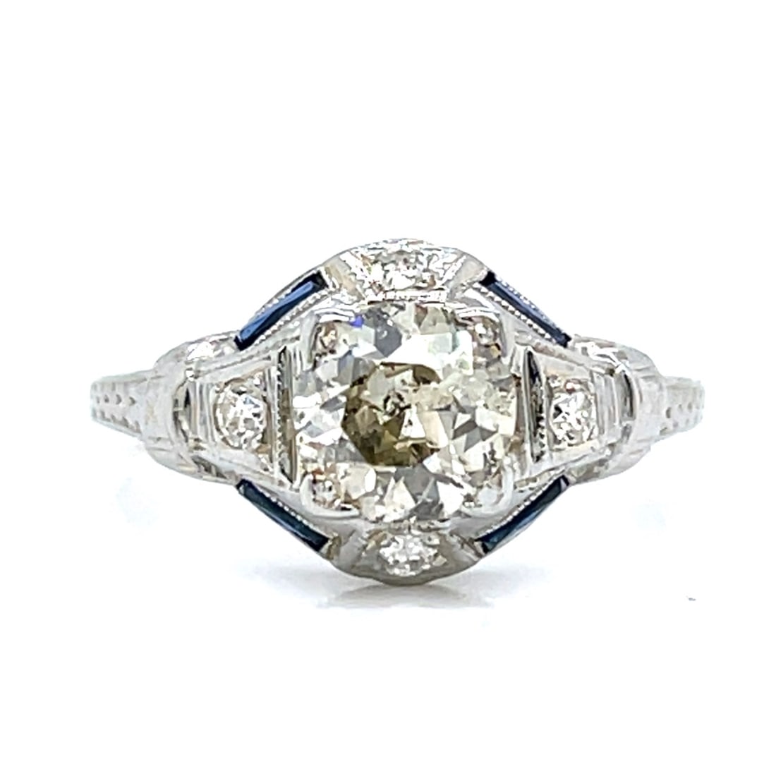Art Deco 18K White Gold 1.00 Ct. Diamond Ring: Art Deco 18K White Gold 1.00 Ct. Diamond RingWeighing 3.1 gramsSet with an app. 1.00 Ct. DiamondN Color, I1 ClarityAlong with 4 Diamonds weighing app. 0.10 Ct.F-G Color, VS1-Si1 ClarityRing Size 6