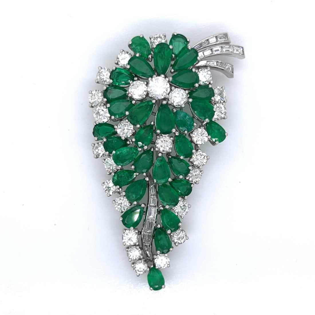 1950’s Platinum Colombian Emerald & Diamond Brooch: 1950’s Platinum Colombian Emerald & Diamond BroochWeighing 24.6 gramsSet with 26 Diamonds weighing app. 5.70 Ct.Along with 18 Baguette Diamonds weighing app. 0.75 Ct.F-H Color, VS1-VS2 ClarityAnd
