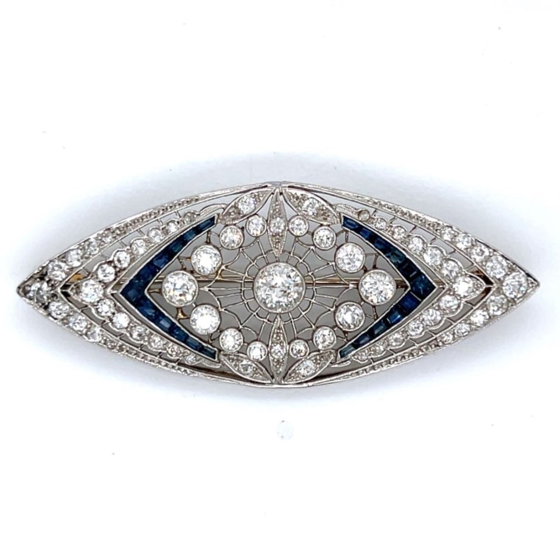 Art Deco Platinum Diamond & Sapphire Brooch: Art Deco Platinum Diamond & Sapphire BroochWeighing 10.1 gramsSet with 65 European-cut Diamonds weighing app. 3.40 Ct.F-H Color, VS1-SI1 ClarityAlong with 22 Sapphires weighing app. 1.00 Ct.2.25 x 1