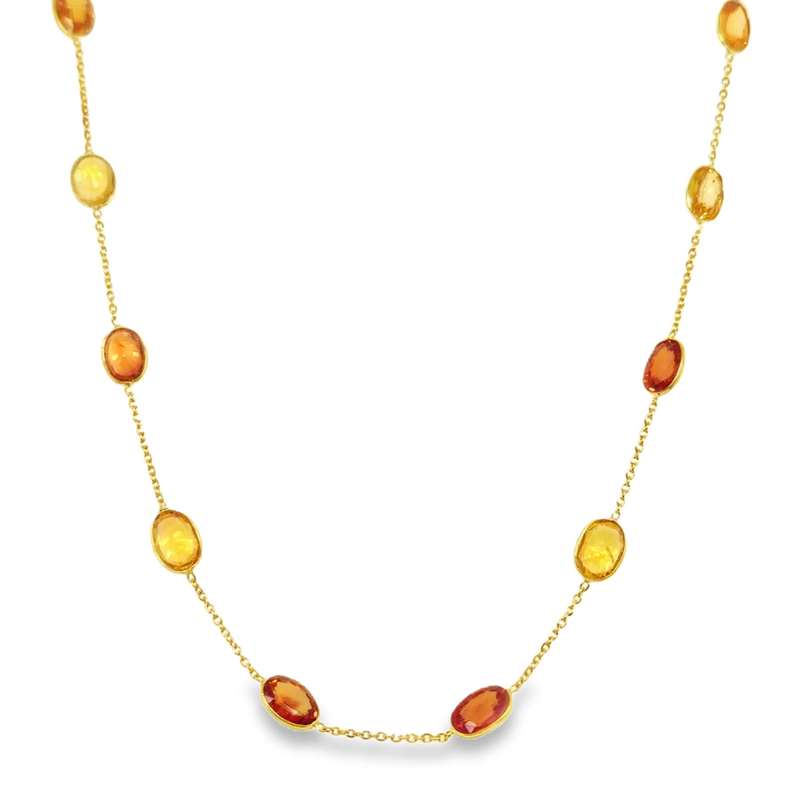 18KT GOLD BAZELED ORANGE AND YELLOW SAPPHIRE STATION NECKLACE: 18KT YELLOW GOLD BAZELED ORANGE AND YELLOW SAPPHIRE STATION NECKLACE 18"18KT GOLD WT. APPROX. 2.45 GRAMSAPPHIRE WT. APPROX. 10.50 CARAT/ 12 PCS18" LONG WITH ADJUSTABLE RING ON 16" AND 17" SAPPHIRE
