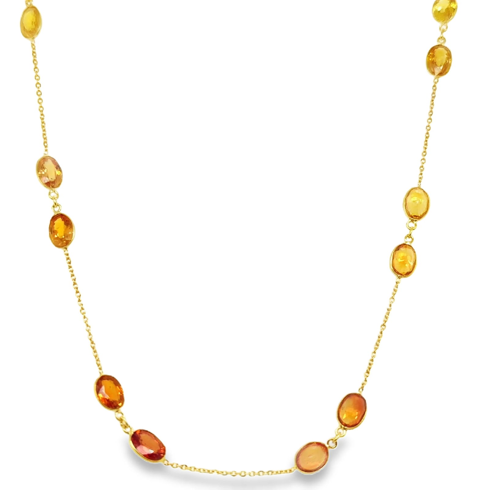 18KT GOLD BAZELED ORANGE AND YELLOW SAPPHIRE STATION NECKLACE: 18KT YELLOW GOLD BAZELED ORANGE AND YELLOW SAPPHIRE STATION NECKLACE 18"18KT GOLD WT. APPROX. 2.45 GRAMSAPPHIRE WT. APPROX. 11.20 CARAT/ 12 PCS18" LONG WITH ADJUSTABLE RING ON 16" AND 17" SAPPHIRE