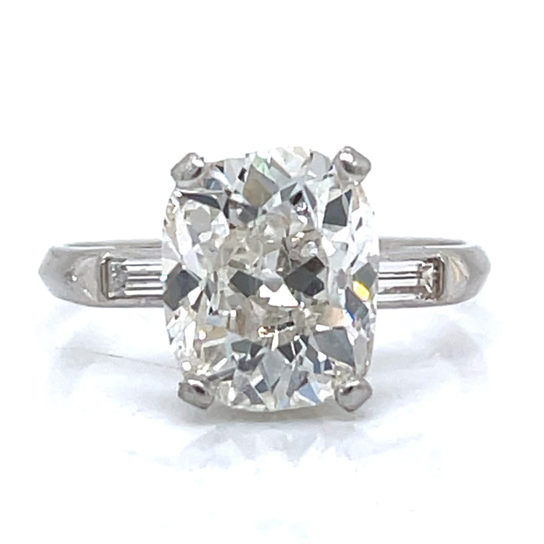 Art Deco Platinum 3.42 Ct. Cushion-cut Diamond Engagement Ring: Art Deco Platinum 3.42 Ct. Cushion-cut Diamond Engagement RingWeighing 3.9 gramsSet with a 3.42 Ct. Old Cushion-cut DiamondG Color, I1 ClarityAlong with 2 Diamonds weighing app. 0.25 Ct.F-G Color,