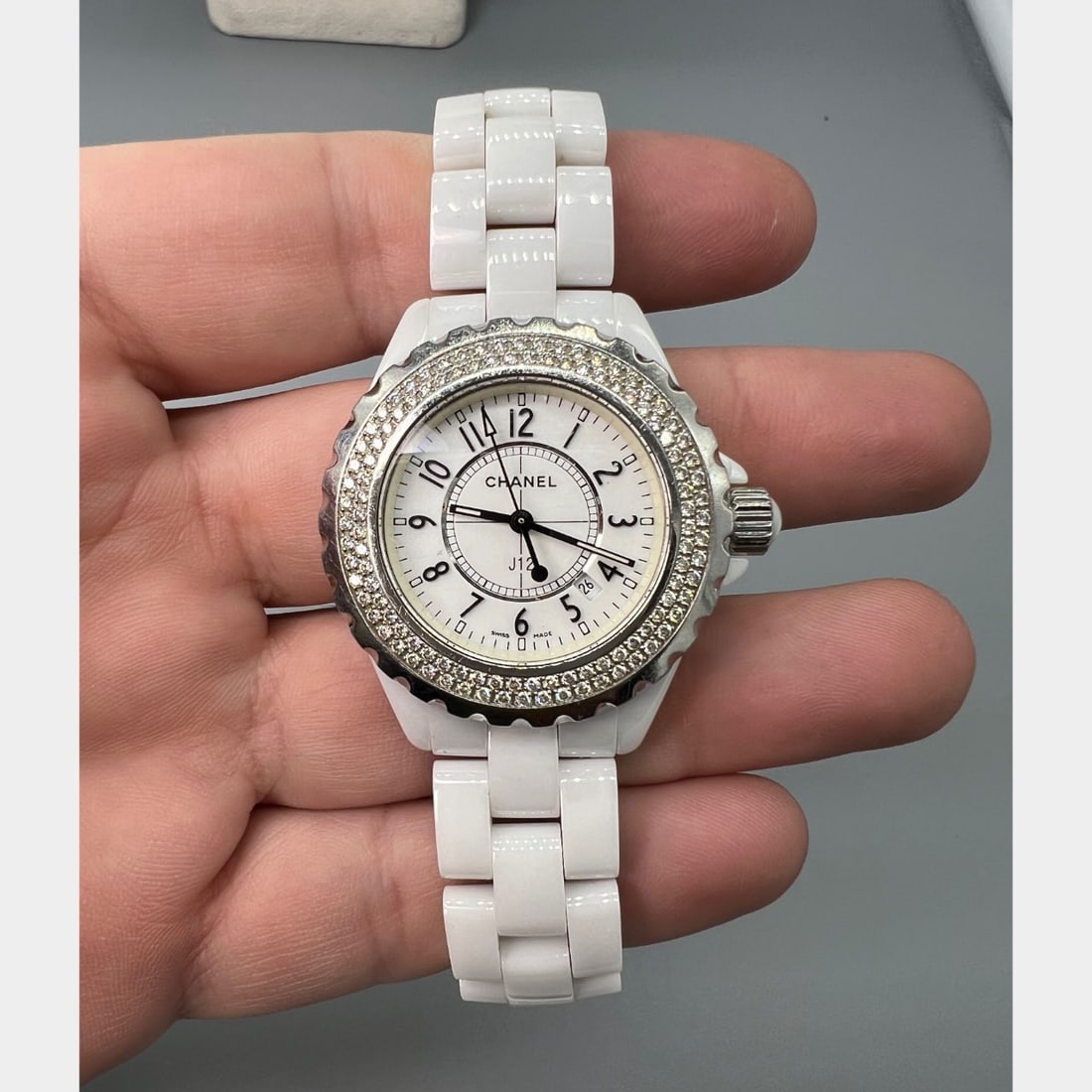 CHANEL White Ceramic J-12 Ladies Watch: CHANEL White Ceramic J-12 Ladies WatchWeighing 100.9 gramsSet with a factory diamond bezel33mm CaseQuartz movementFits 6.5 inch wrist
