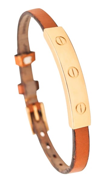 CARTIER Paris 1978 Vintage Love Leather Buckle Belt Bracelet In 18Kt Yellow Gold: Love belt bracelet designed by Cartier.This is the iconic bracelet from the Love collection, created in Paris France by the jewelry house of Cartier. This belt bracelet has been crafted with parts in