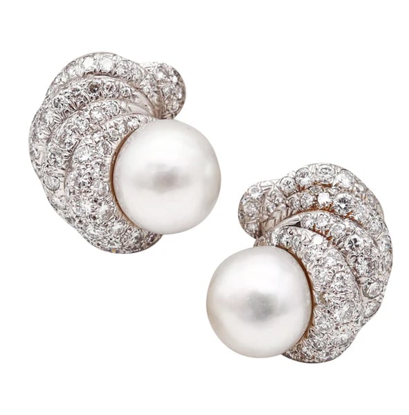 DAVID WEBB 1977 South Seas Pearls Clips-On Earrings Platinum And 8.84 Cwt Diamonds: Pair of clips-on earrings designed by David Webb (1925-1975).This is an extraordinary pair of clips-on earrings created in New York City at the jewelry atelier of David Webb, back in the 1976-77. Thes
