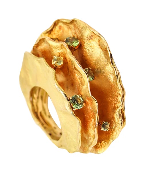 AUDE LECHERE Sculptural Cocktail Ring In 18Kt Yellow Gold With Green Sapphires: An sculptural ring designed by Aude Lechère. This is a fantastic sculptural ring created in Paris France by the artist-jeweler Aude Lechère. The ring is part of a limited edition of only seven piece