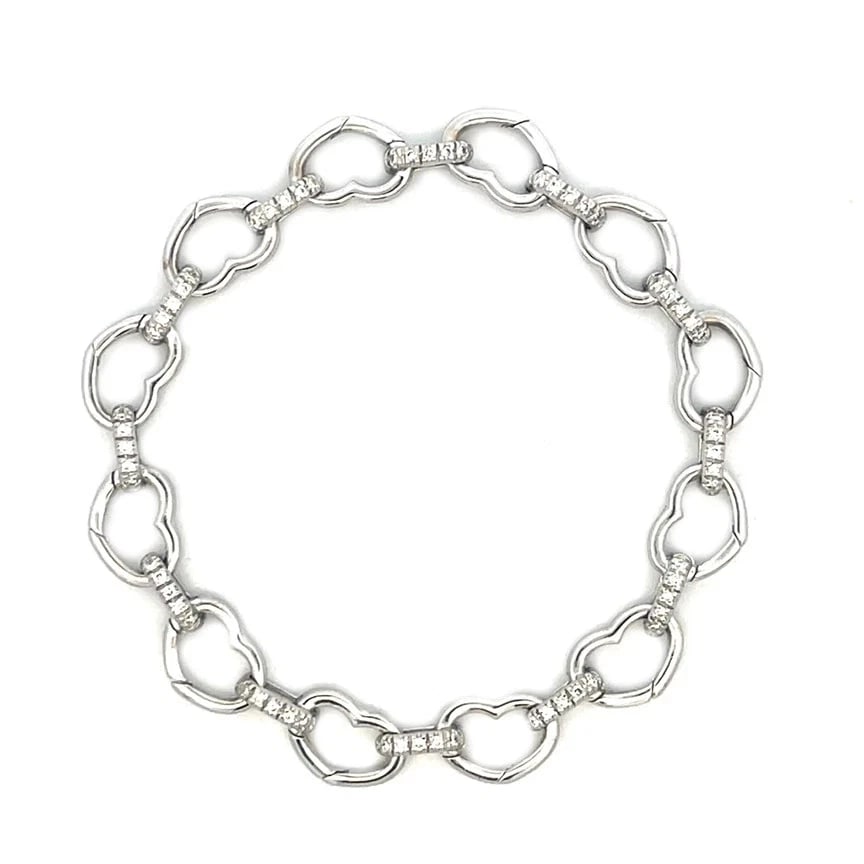 Aaron Basha Diamond Gold Bracelet Hearts Clasping Link Style: The Aaron Basha Diamond Gold Bracelet is a luxurious piece of fine jewelry featuring alternating diamond oval links with polished heart shape clasping links. The oval links are design with a pavé