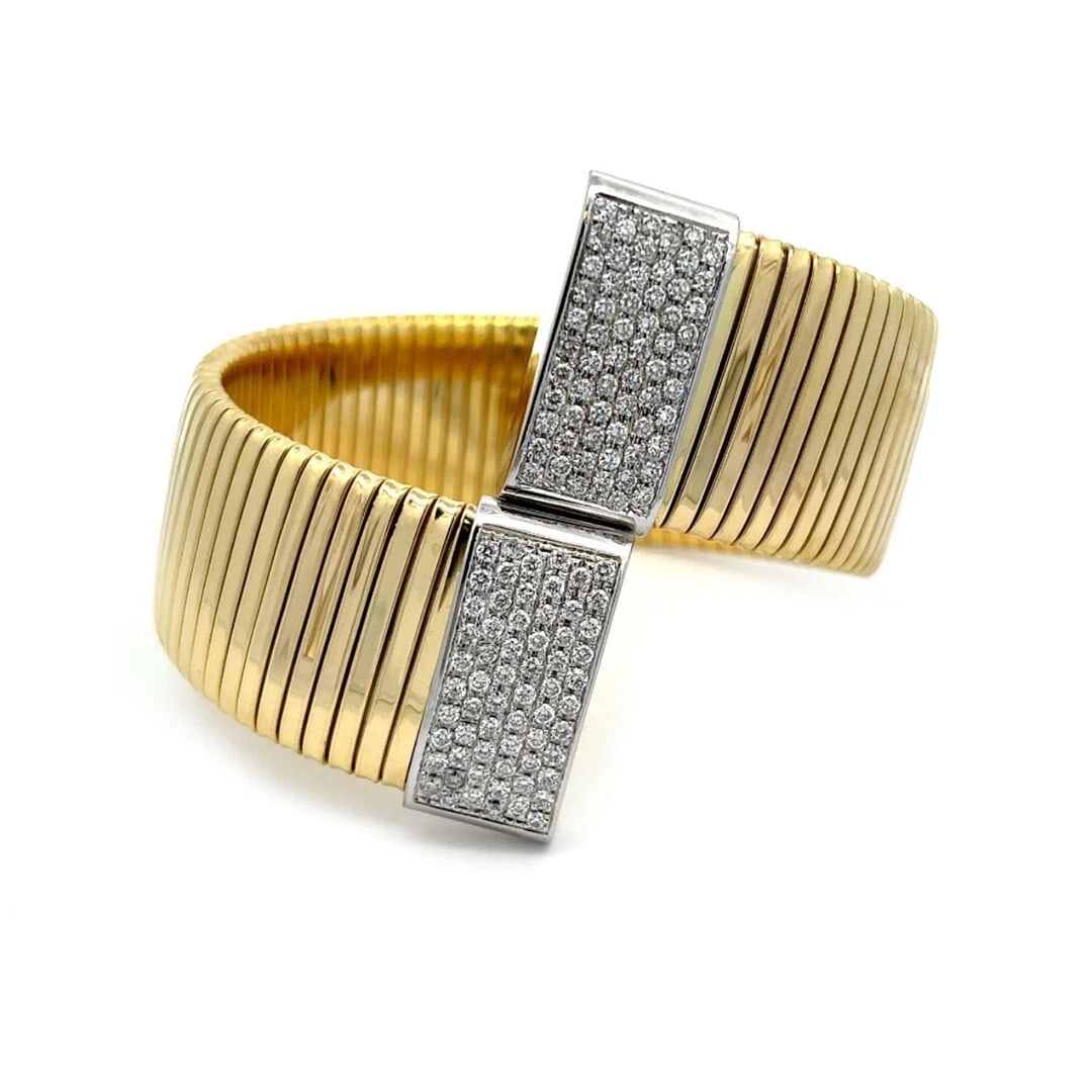 Snake Gold Bracelet Diamonds 18k Yellow 23mm Wide Tubogas Bypass: This is a chic fashionable wide flex bracelet, it is crafted from 18k yellow and white gold featuring a 23mm wide with the tubogas design in yellow gold with white gold band on each end of the bracele