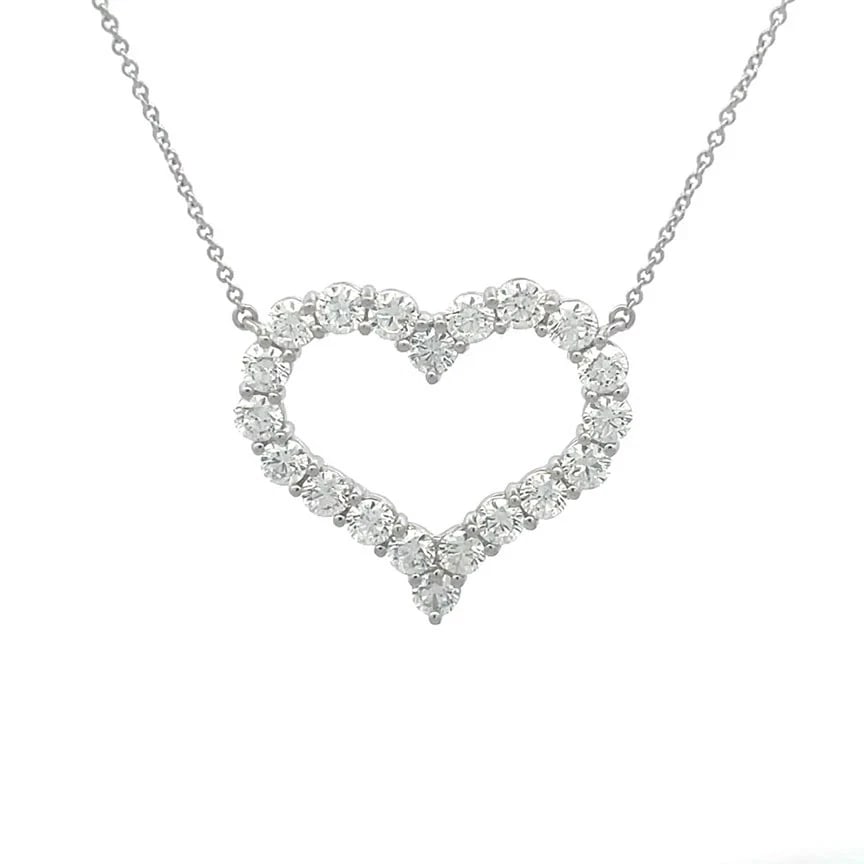 Tiffany & Co. Diamond Heart Necklace Platinum Prong Set Open Style Box: The product is a stunning Tiffany & Co. diamond necklace featuring a gorgeous open style curved shape heart with prong set natural white diamonds on platinum, an oval link chain is attached to the pen