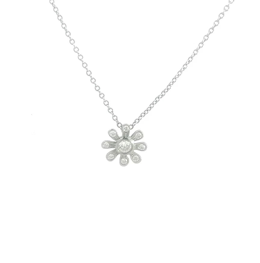 70979 Tiffany & Co. Picasso Daisy Necklace Diamond Platinum Pendant Chain: The Tiffany & Co. Picasso Daisy Necklace is a lovely piece of fine jewelry featuring a platinum pendant with a daisy flower shape design, accented with a round white diamond in a bezel setting. The ne