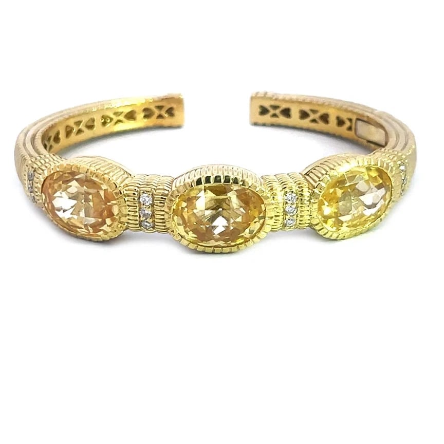 Judith Ripka Diamond Gold Bracelet 18k Yellow 3 Stone Cuff Style: The Judith Ripka Diamond Gold Bracelet is a stunning piece of fine jewelry featuring a cuff style design with three oval-shaped yellow stone accented with diamonds set in 18k yellow gold. This