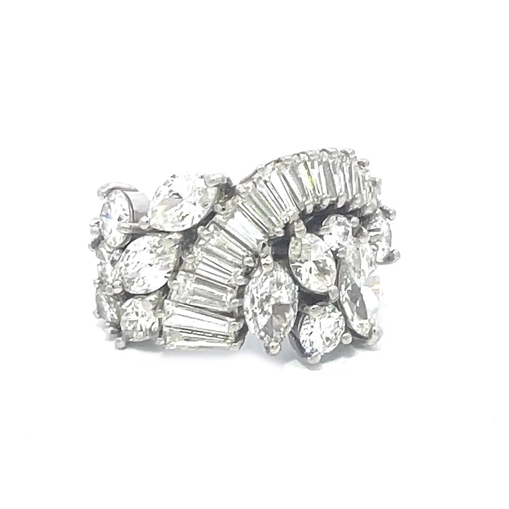 70396 Diamond Platinum Ring 6 Carats Cluster Assorted Shape: This is a stunning platinum cocktail ring, the tapered band has baguette which continued from the back to the front in a wide curved design with graduated size baguettes, on each side of the curve