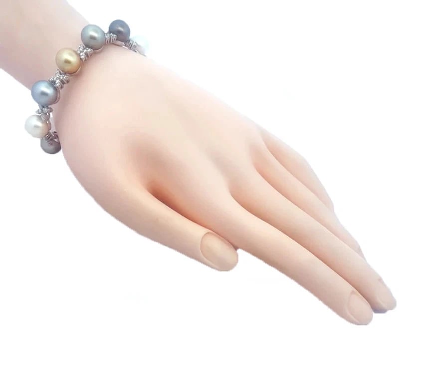 Diamond Gold Bracelet 18k White Multicolor South Sea Pearls X Link Style: This lovely pearls and diamond bracelet is crafted from 18k white gold, it features alternation 10mm pearls with diamond set X links, the pearls are dark and light gray, white and yellow. The X link s