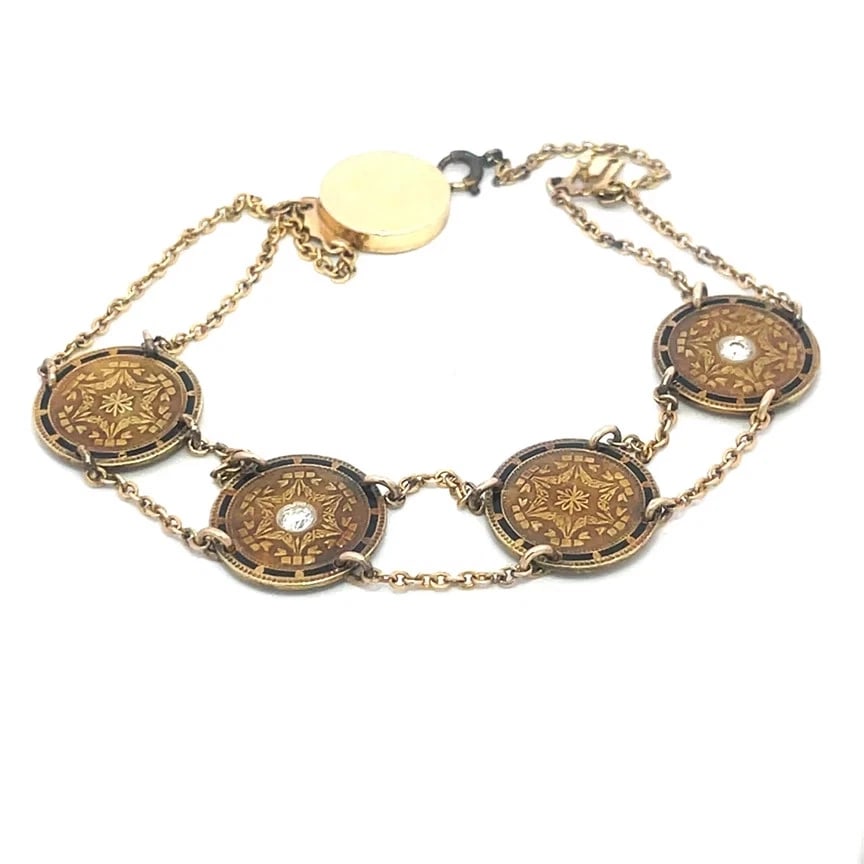 Victorian Diamond Gold Bracelet 14k Yellow Enamel 4 Coin Motifs Chain Style: This is a lovely Victorian Era gold bracelet, is a stunning piece of antique jewelry that features four floral coin motifs in 14k yellow gold, two with a round cut diamond in the center, all accented