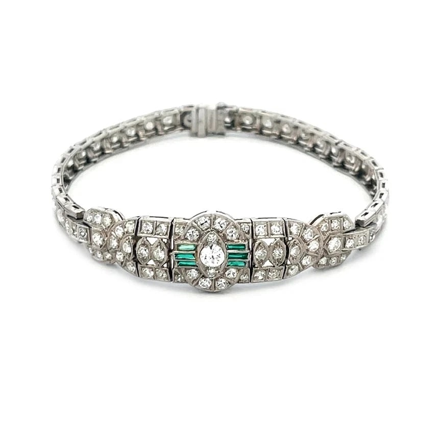 Art Deco Diamond Platinum Bracelet Fancy Centerpiece Milgrain Style: This Art Deco diamond platinum bracelet features a fancy centerpiece with a milgrain border around the diamonds and green stone. The bracelet is crafted with platinum, and the diamonds are set in a pr
