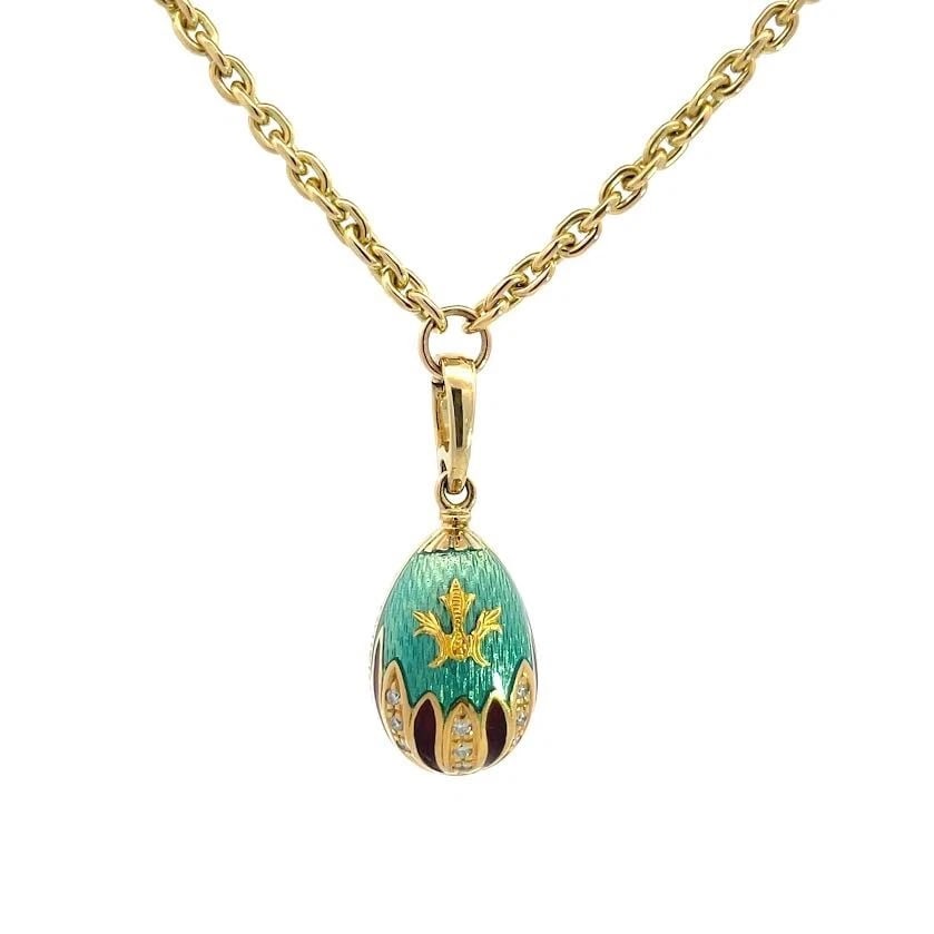 Faberge Diamond Egg Pendant Necklace 18k Yellow Gold Guilloche Enamel: This is an authentic Faberge egg pendant and chain necklace. It is crafted from 18k yellow gold with a polished finish. The pendant features an egg shape in green guilloche enamel and on the front of