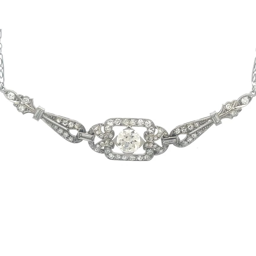 Art Deco Diamond Platinum Necklace Fancy Centerpiece Filigree Chain: This sparkling Art Deco Diamond Platinum Necklace features a fancy east west centerpiece with stunning round white diamond set in the center of a rectangle frame accented with smaller diamonds, attach