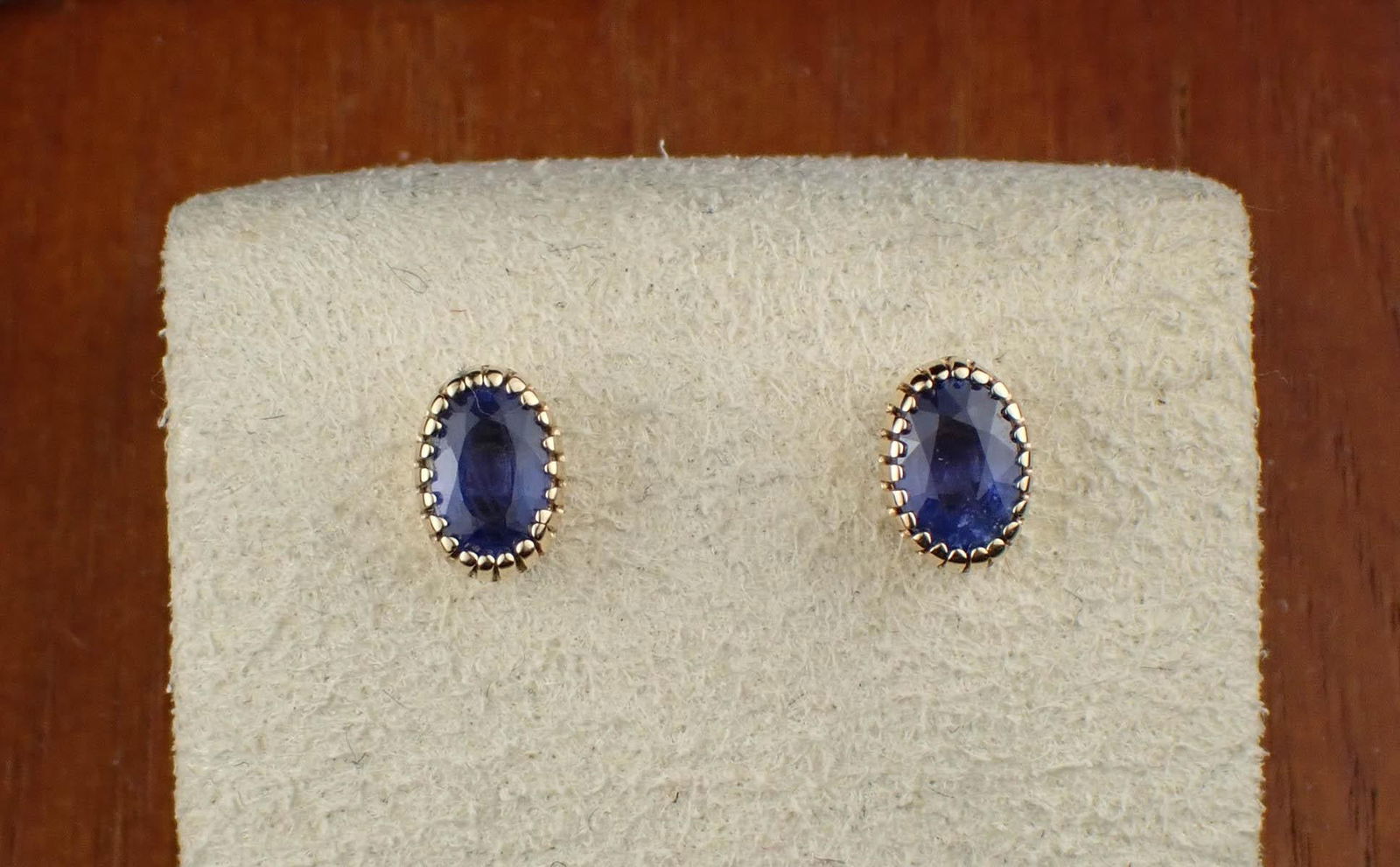 PAIR OF SAPPHIRE & 14K GOLD EAR STUDS: PAIR OF SAPPHIRE & 14K GOLD EAR STUDS:each yellow gold ear stud set with an oval-cut blue sapphire. The two sapphires together weigh approximately 1.12 cttw. The gold post on each ear stud is stamped