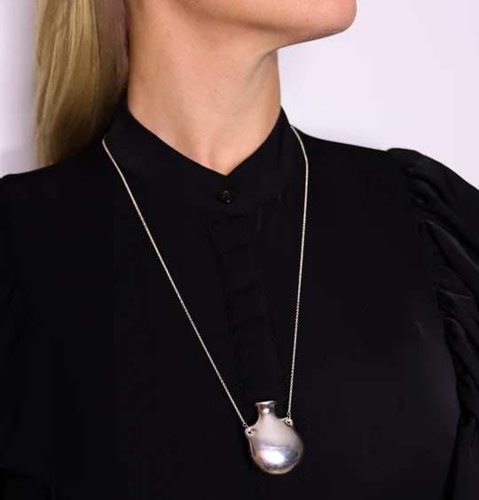 TIFFANY & CO. By Elsa Peretti Medium Freeform Open Bottle Necklace In 925 Sterling: Open bottle necklace designed by Elsa Peretti (1940-2019) for Tiffany & Co.This beautiful freeform open bottle was created in New York City by Elsa Peretti for the Tiffany & Co. back in the early 1980