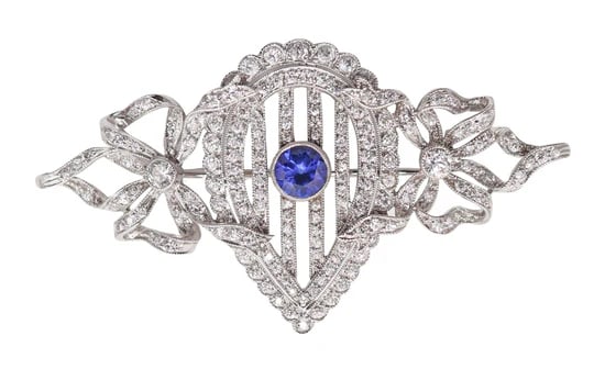 J.E. CALDWELL 1910 Edwardian Brooch In Platinum With Diamonds & Sapphire: An Edwardian brooch designed by J.E. Caldwell & Co.This is an important antique brooch created in America by the Philadelphia based goldsmiths of J.E. Caldwell & Co. between the 1900 and 1910. This be