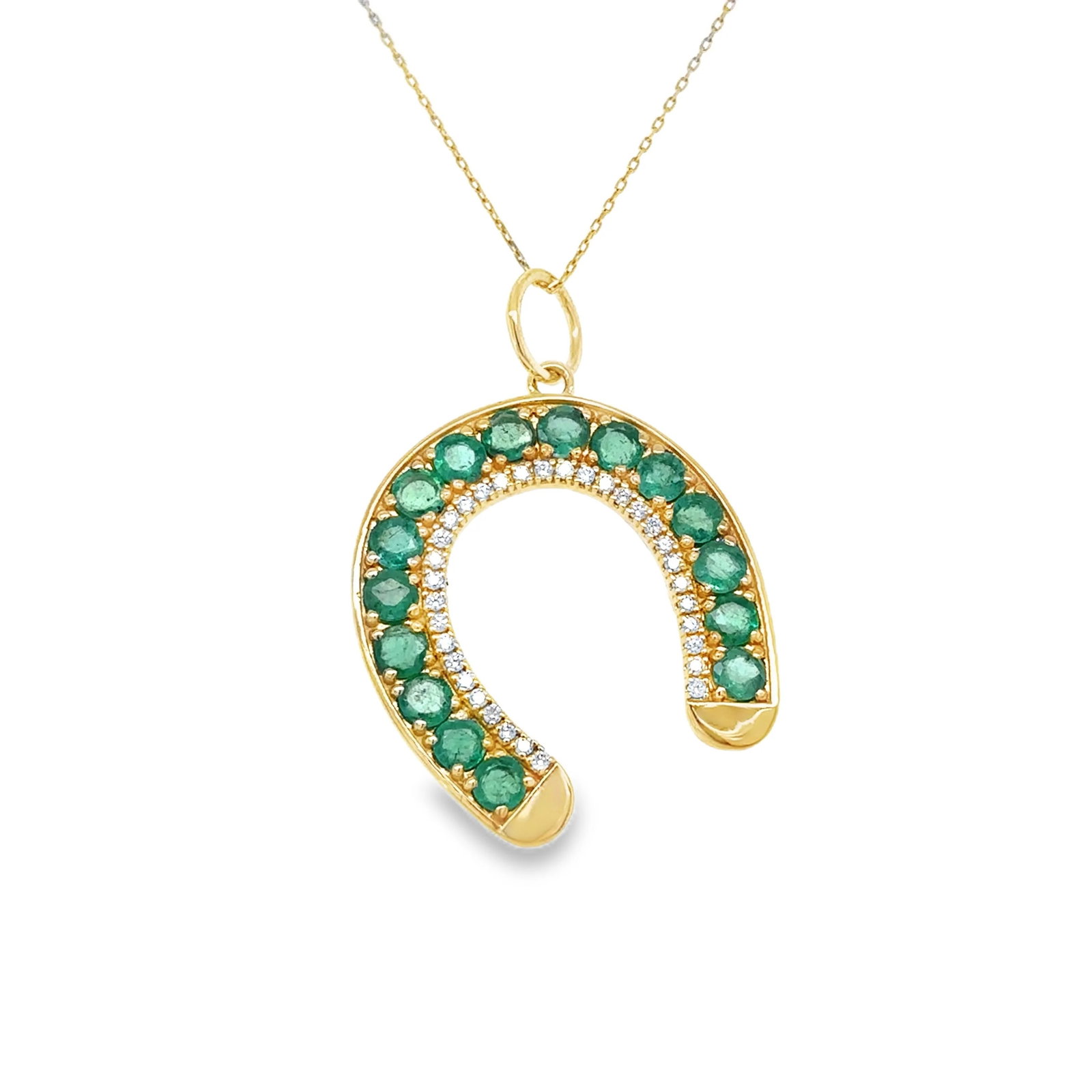 14KT GOLD EMERALD HORSESHOE PENDANT: 14KT YELLOW GOLD EMERALD HORSESHOE PENDANT14KT. YELLOW GOLD WT. APPROX. 2.58 GRAMDIAMOND WT. APPROX. 0.20 CTEMERALD WT. APPROX. 2.05 CT/ 16 PCSSIZE: 23 MM X 26 MM