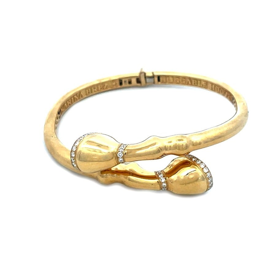 Karina Brez Diamond Gold Bracelet Bypass Horse Hooves Flex Bangle: This eye-catching equestrian bracelet is by designer Karina Brez, from 18k yellow gold with a high polished finish, it features a unique design showcasing horse hooves accented with white natural diam