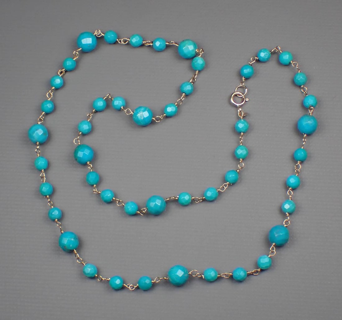 TURQUOISE & 14K YELLOW GOLD NECKLACE: TURQUOISE & 14K YELLOW GOLD NECKLACE:17-3/4 inch with 47 turquoise faceted round beads measuring between 4mm and 6.5 mm in diameter and ending with a yellow gold spring ring clasp stamped "585" and "1