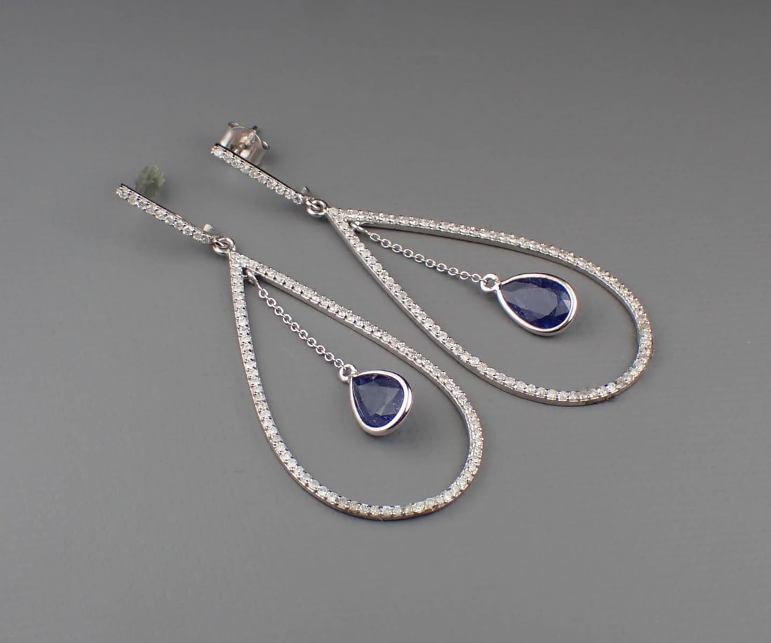 PAIR OF SAPPHIRE, DIAMOND & 18K GOLD EARRINGS: PAIR OF SAPPHIRE, DIAMOND & 18K GOLD EARRINGS:each white gold dangle earring features a pear-cut sapphire accented with 90 round-cut diamonds. Total combined estimated weight for both sapphires: 2.72 