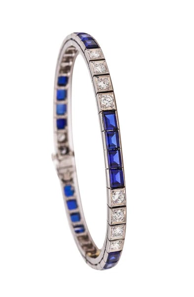 An Art-Deco Riviera bracelet with gemstones.Very elegant piece from the late American Art-Deco: An Art-Deco Riviera bracelet with gemstones.Very elegant piece from the late American Art-Deco period, circa 1940's. This sleek Riviera tennis bracelet was crafted in solid white gold of 14 karats, wi