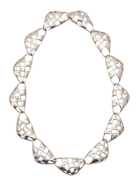 Sculptural necklace designed by Angela Cummings.This is a beautiful sculptural necklace created by: Sculptural necklace designed by Angela Cummings.This is a beautiful sculptural necklace created by Angela Cummings at her own silversmith studio in New York City, back in the 1987. The flexible neckla