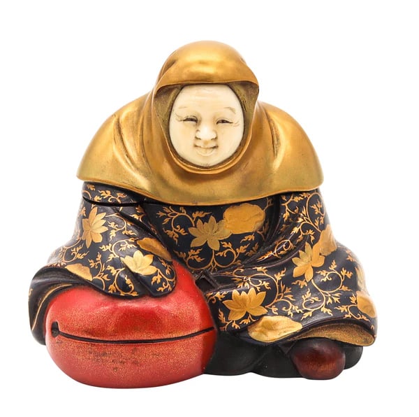 A Meiji lacquered box in the shape of a seated lady made by Meigetsusai Kazuyoshi.This is a n: A Meiji lacquered box in the shape of a seated lady made by Meigetsusai Kazuyoshi.This is a n extremely rare decorative box made in the shape of a fully dressed seated holding a temple's bell. The fan