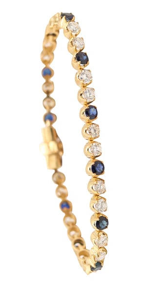 TIFFANY & CO. Riviera Bracelet In 18Kt Yellow Gold With 7.68 Cwt Diamonds & Sapphires: A Riviera bracelet designed by Tiffany & Co.This is a colorful riviera line bracelet created in New York City by the American jewelry company of Tiffany & Co. This bracelet was crafted with flexible l