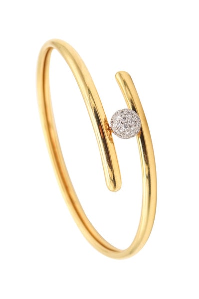 TIFFANY & CO. Bypass Bracelet In 18Kt Yellow Gold Platinum And VS Diamonds: A bypass bracelet designed by Tiffany & Co.This is a rare and exceptional bypass bracelet created in New York City by the prestigious American jewelry house of Tiffany & Co. A remarkable example of re