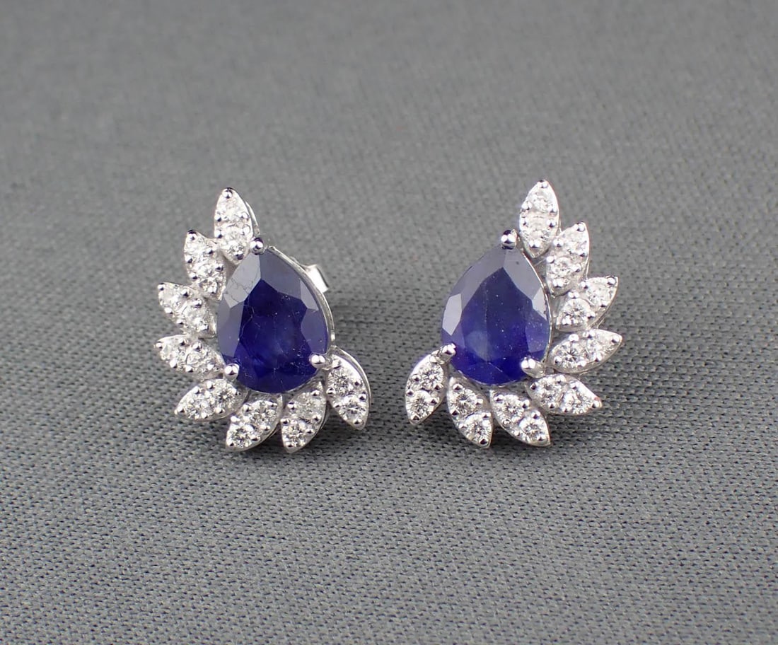 PAIR OF SAPPHIRE, DIAMOND & 14K GOLD EARRINGS: PAIR OF SAPPHIRE, DIAMOND & 14K GOLD EARRINGS:each white gold earring features a pear-cut sapphire accented with eight pairs of round-cut diamonds. Total combined estimated weight for both sapphires: 
