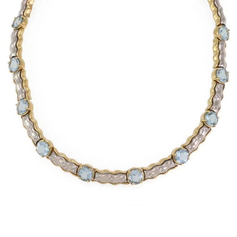 Diamond Gemstone Necklace 18k Two Tone Gold Collar: This Diamond Gemstone Necklace features a stunning blue gemstone set in an 18k two-tone gold collar. The necklace has a length of 16.75 inches and showcases a round main stone shape. The beauty of